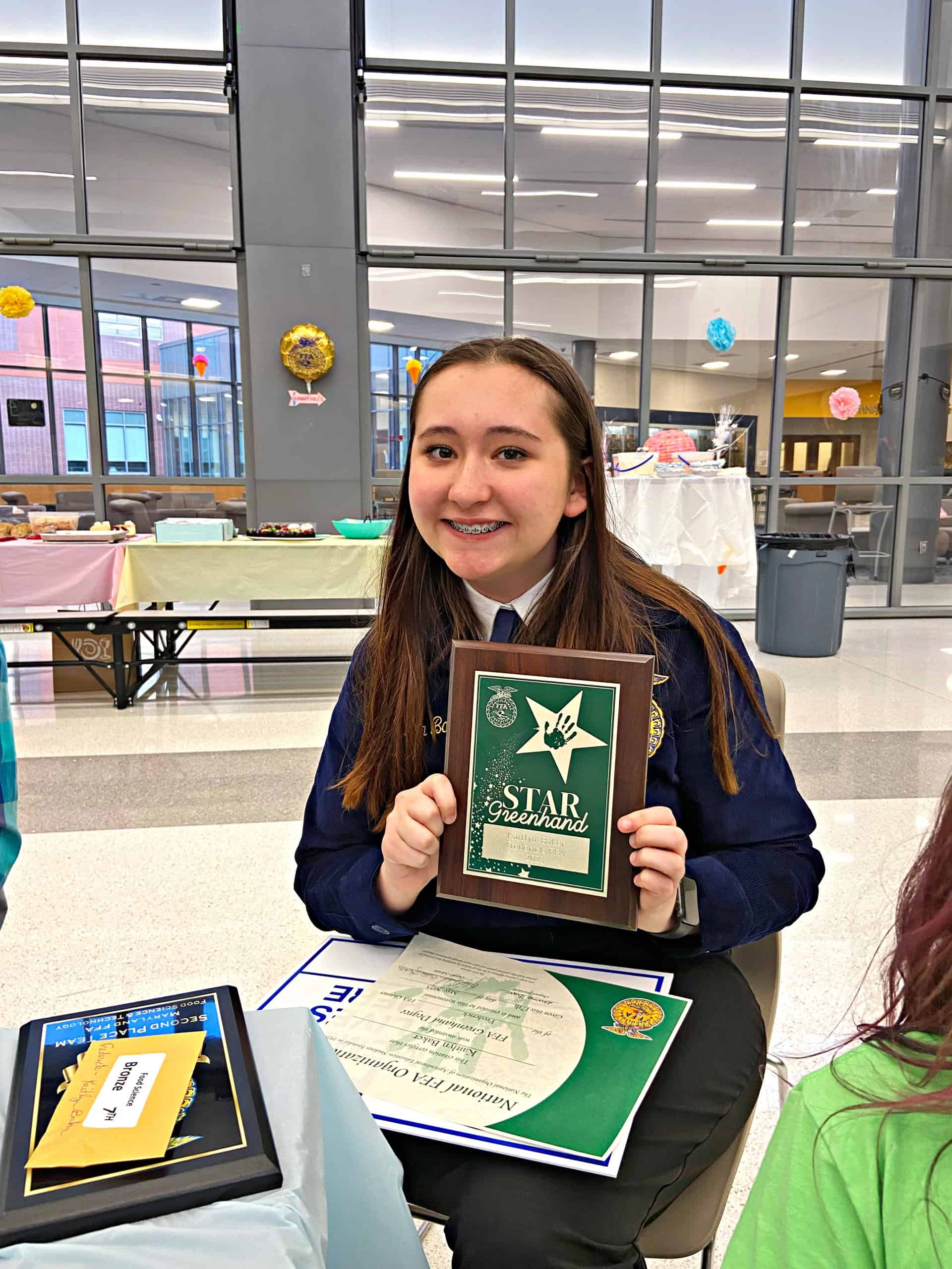 Kaitlyn Baker from Frederick, Maryland showing her Greenhand degree.