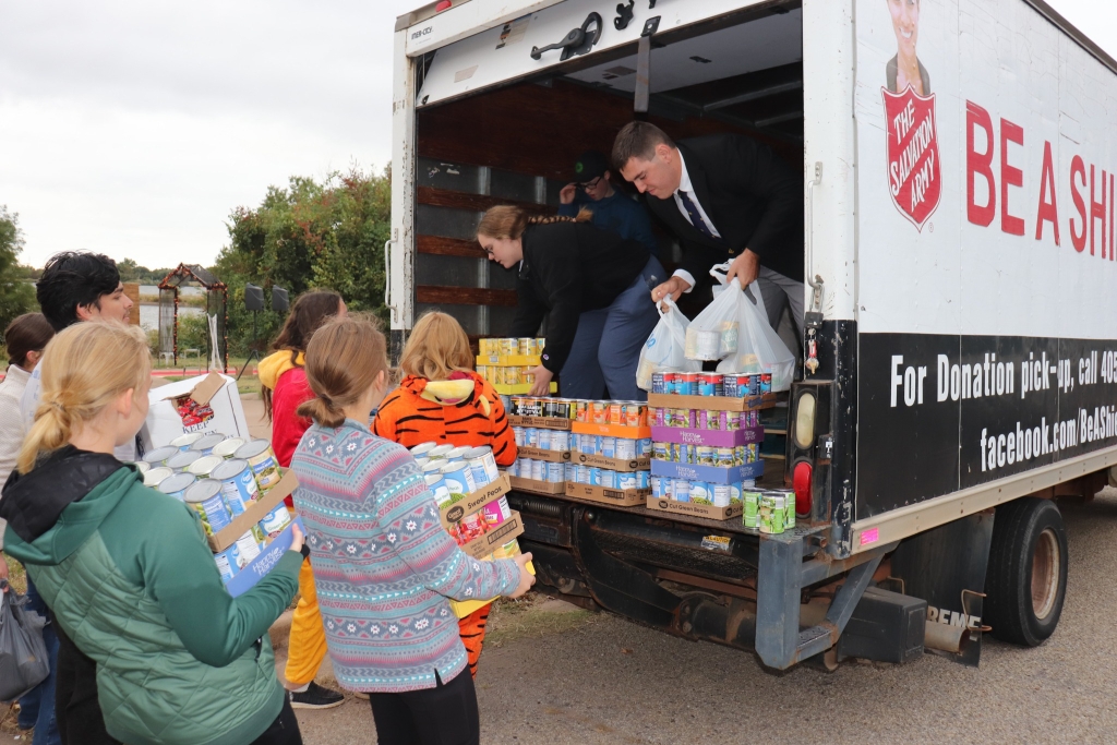Stillwater FFA members load more than 4,800 canned food items into a Salvation Army truck.