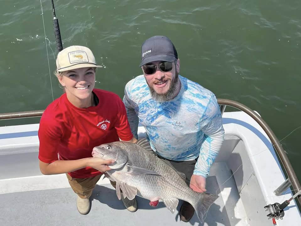 Forrest Kent-Teichmann (left) on charter fishing boat named The Captain’s Lady.