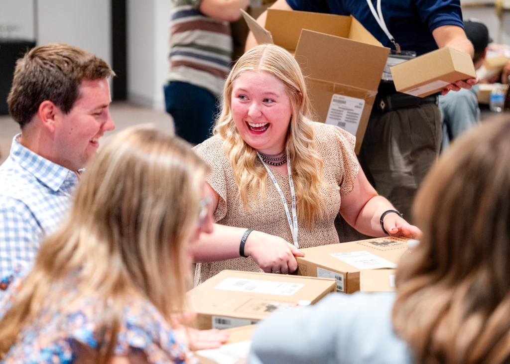 2024 New Century Farmer participants (also pictured above) react to receiving donated laptop computers and headsets from Microsoft.