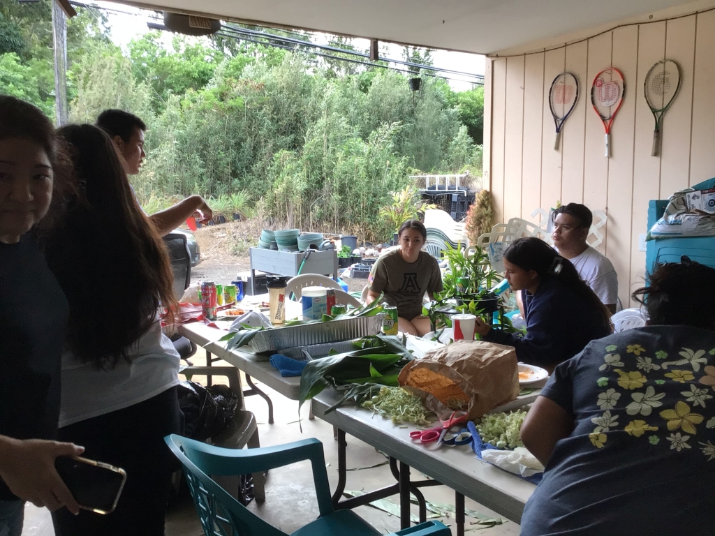 Kenneth Matsuda (wearing the white shirt) oversees a lei making gathering with fellow FFA members