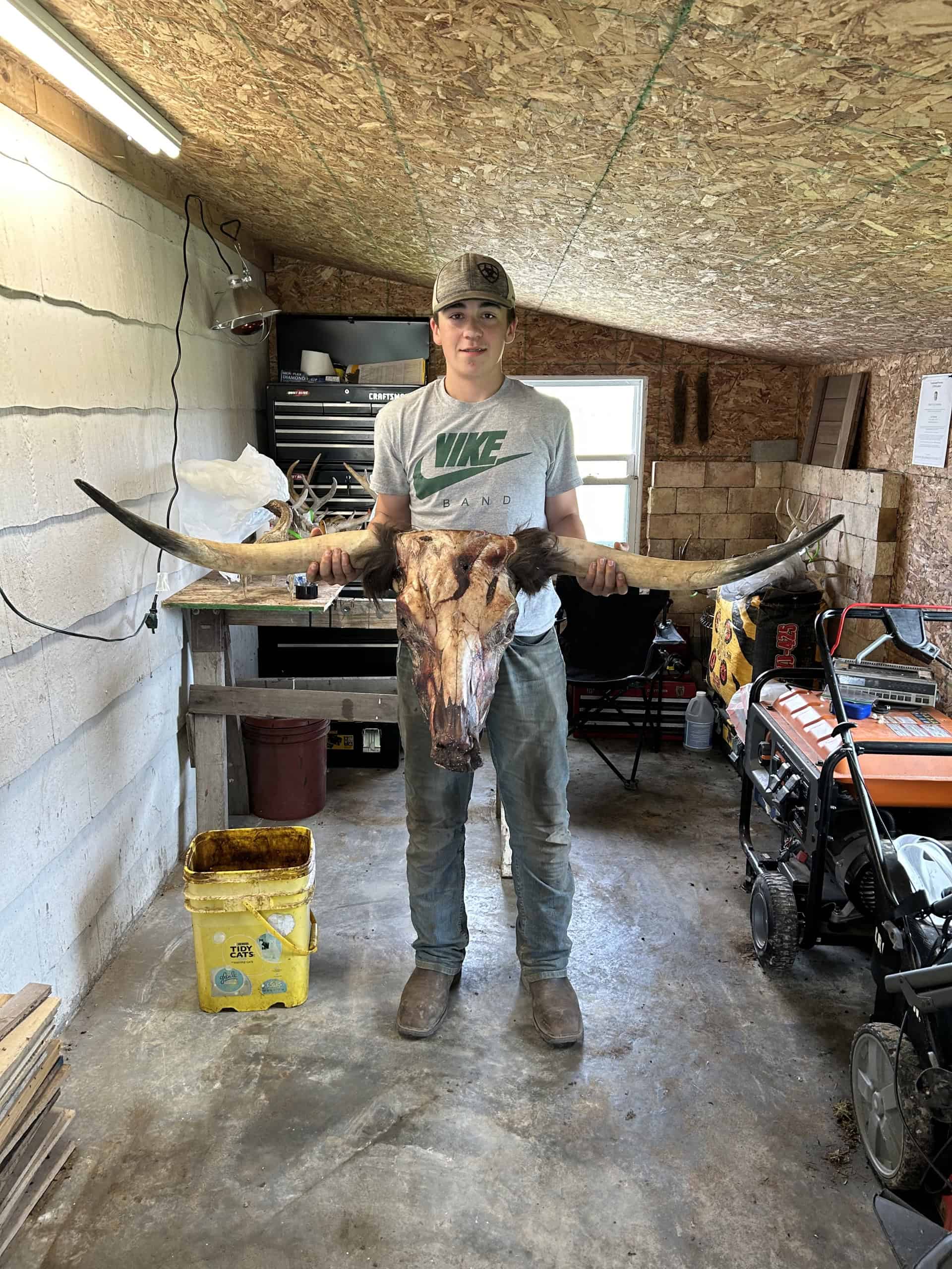 Nate Emmons holds his favorite taxidermy piece, a longhorn skull mount.