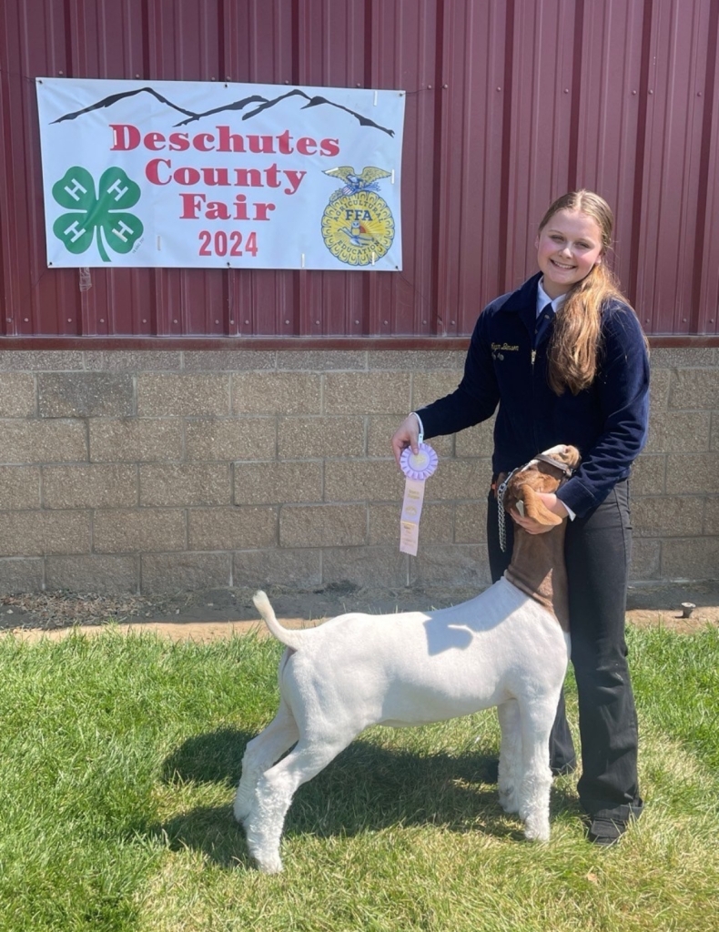 Megan Benson with her FFA reserve champion market goat at the county fair.