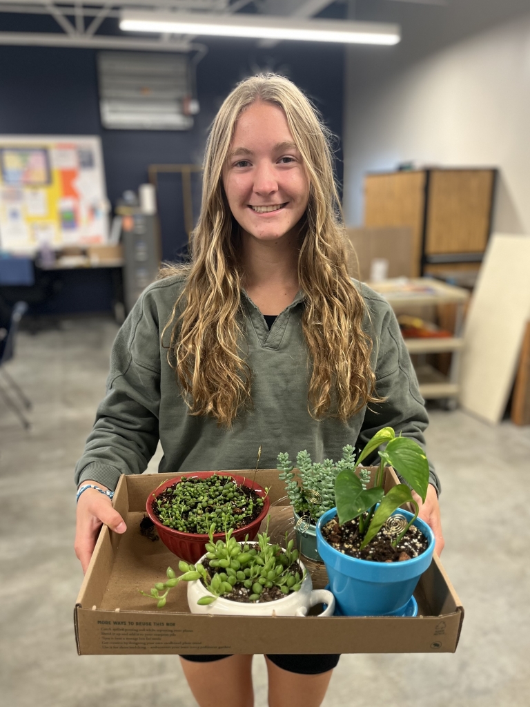 Clara Ankeny holds her succulent display for the Nebraska State Fair.