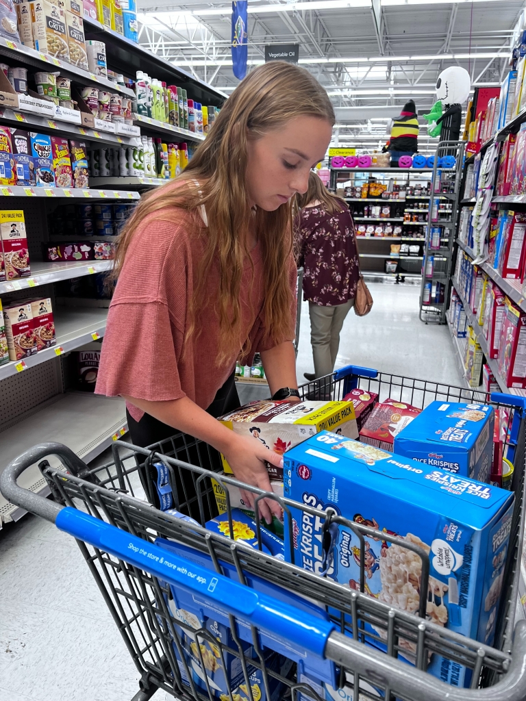 Hines shopping for items to stock the food pantry.