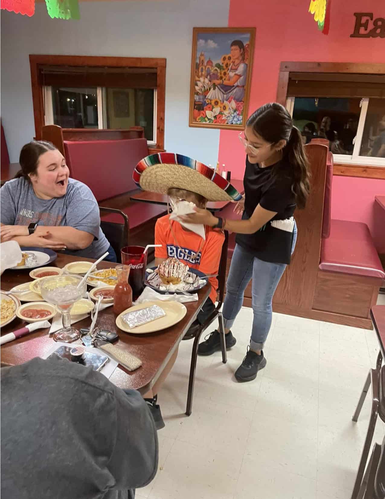 Selena Fuentes is seen smashing the birthday boy in the face with whipped cream. This is a tradition at the three restaurants, if it is your birthday, you get to wear a sombrero and get "whip creamed."