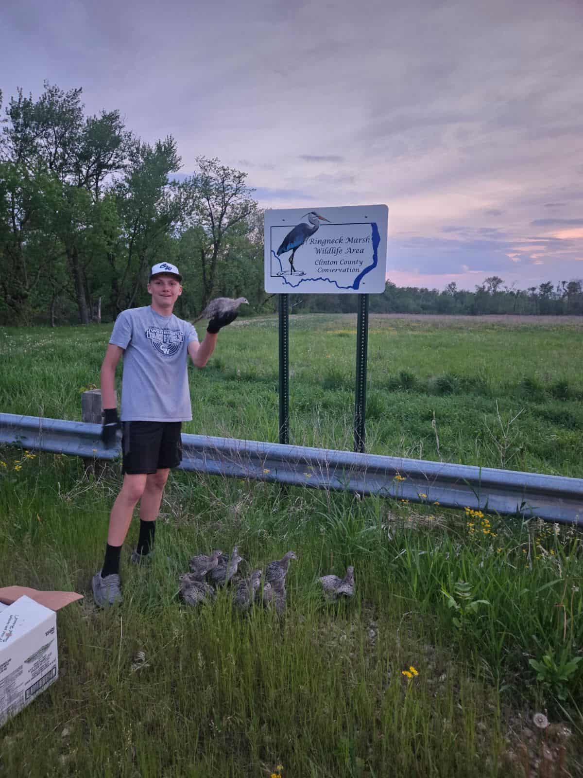 Aidan Yaddof poses with a few birds he released near his house in eastern Iowa. 