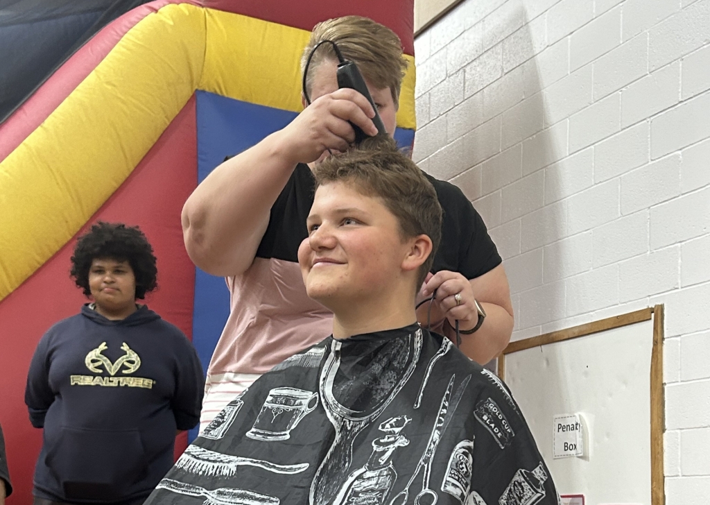 Granton FFA Treasurer Kadyn Marg gets his head shaved after surpassing the donation goal.