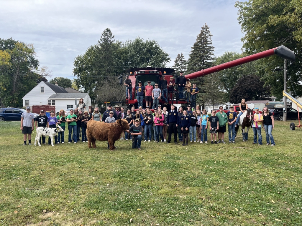 The Blooming Prairie FFA Chapter poses in front of a combine at their Farm Safety Day.