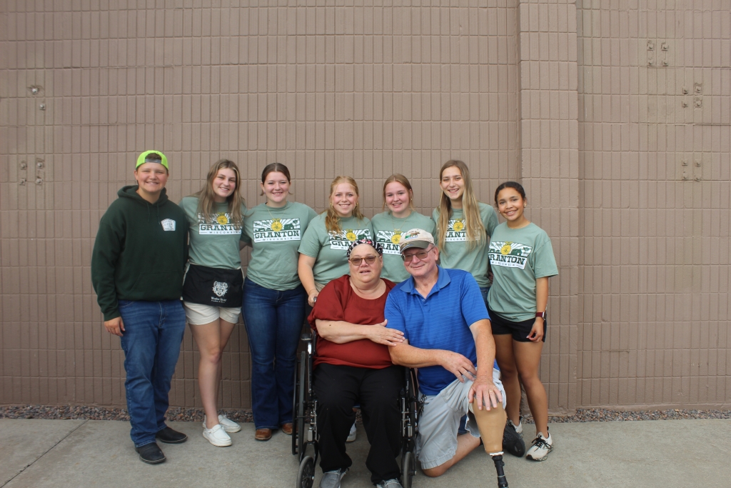 Tim and Cheryl Steinbach (front center) smile with the 2024-25 Granton FFA officer team.