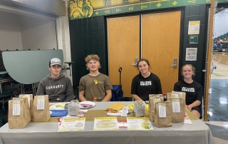 FFA members volunteered to help collect donations at the volleyball game.