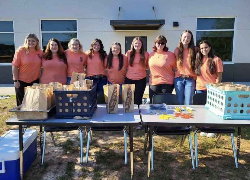 The UCAHS FFA officer team outside the agriculture classroom with the drive-through set up.