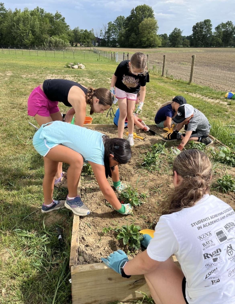 Ava and Lyla Susong teach campers about horticulture and gardening.