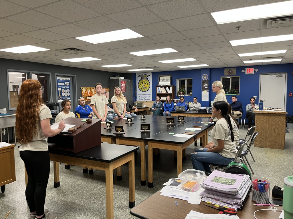 Team members present proper meeting procedures to school board members.