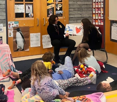 Odessa FFA Chapter members read to a second grade class about products different animal species provide for our everyday life during their pajama day.