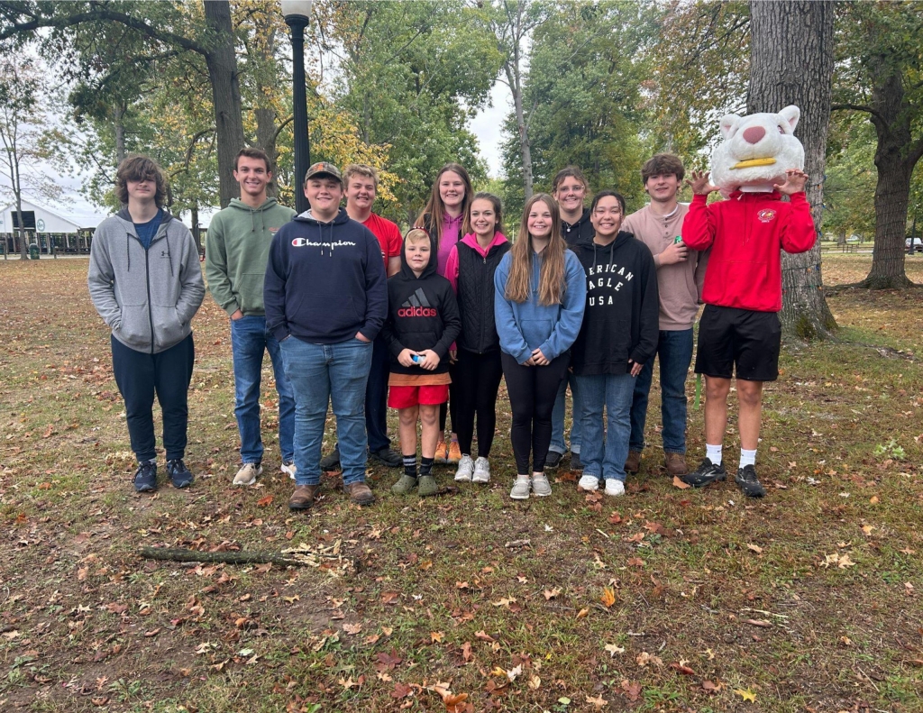 Olney FFA members taking a group picture before splitting up to count the squirrels at the White Squirrel Count. They even got to try on the costume!