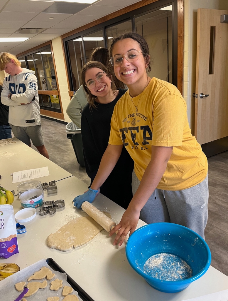 Breanna Stratton and Shelby Dimiceli follow the dog treat recipe.