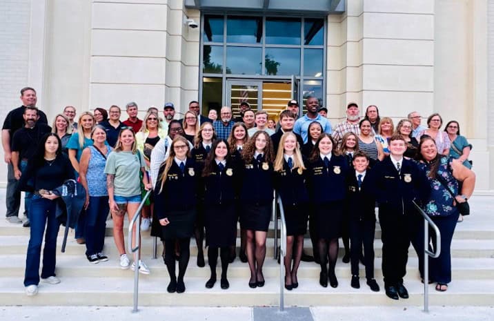 Ocoee High School FFA members and supporters stand in front of the Ocoee City Hall.