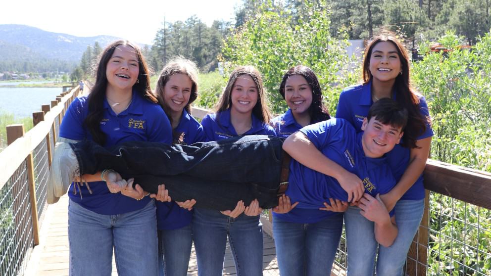 Officer team united! Audree Callens, Kayzen Hickingbottom, Addison Castro, Aubrey Cazares and Melanie Perez pose while holding Connor Chalupnik during the officer retreat.