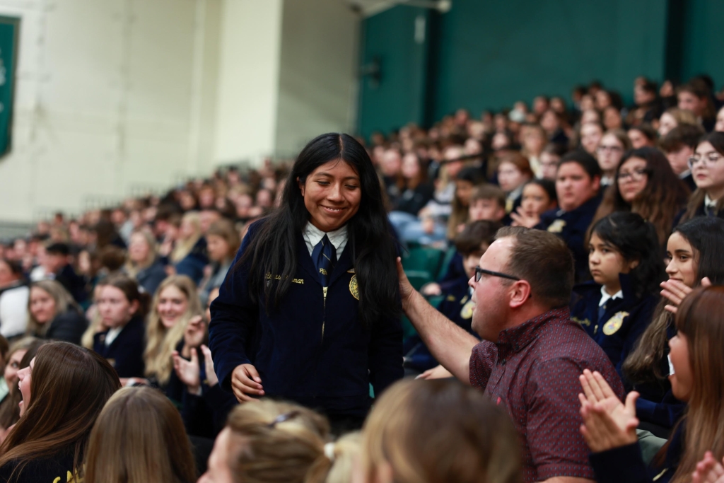 Russell Zimmerman (right) congratulates Lexus Gusman (standing) after winning first high individual at the California FFA state CDE finals.