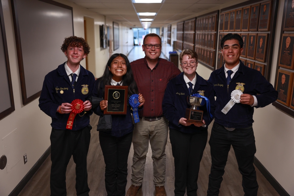 Nipomo High School FFA members Tyler Korsberg, Lexus Gusman, Andy Hatch and Raymond Marquez pose with their advisor, Russell Zummerman (center), and their achievements.