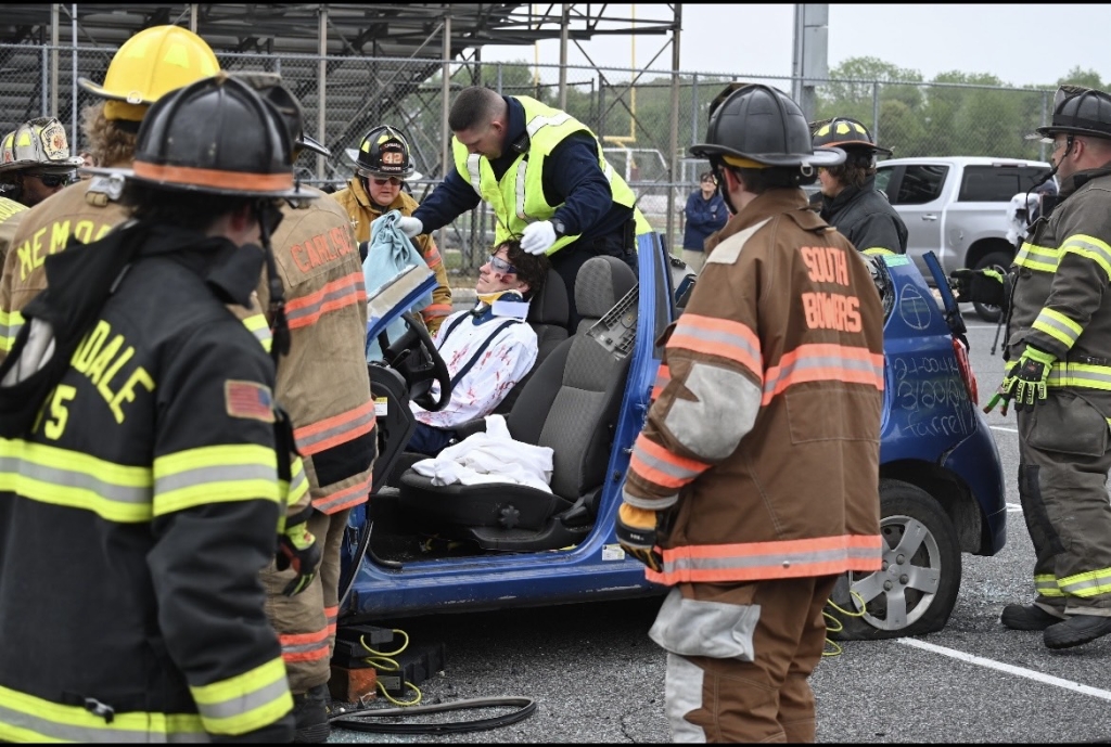 Medical professionals provide medical attention to senior Landon Hudson during the staged demonstration.