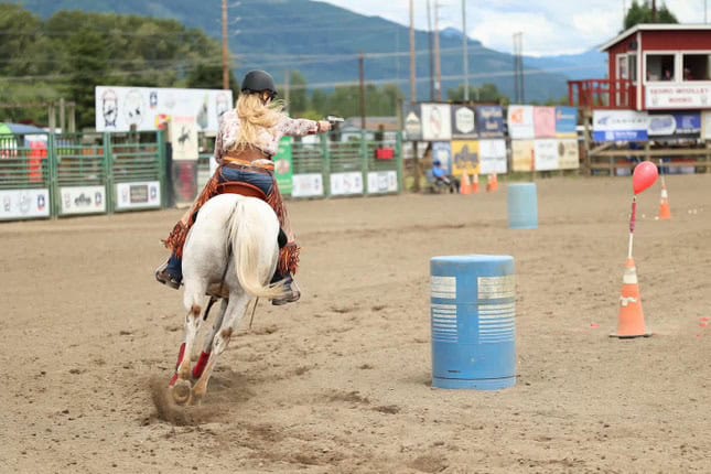 Hannah Lee and her horse, Pepper, aim for a balloon target.