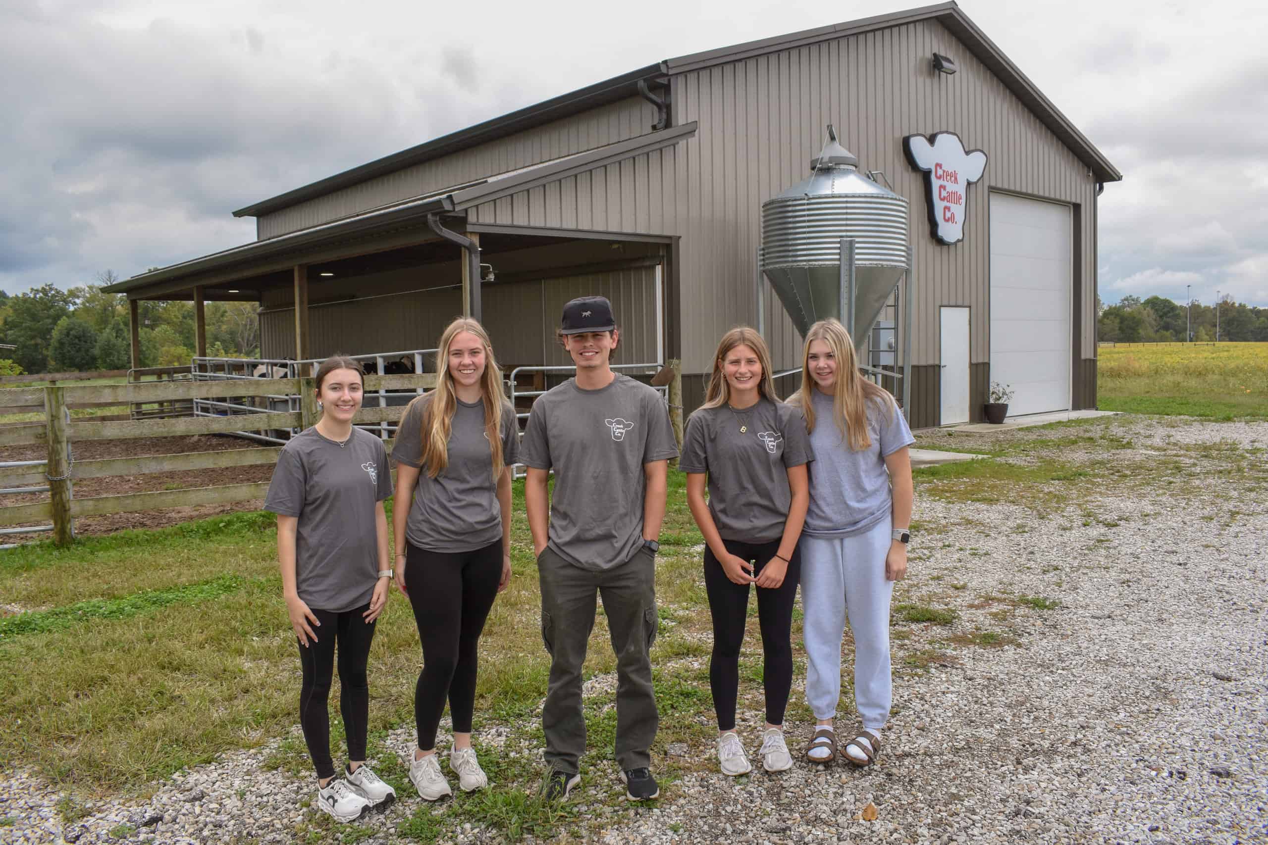 Creek Cattle Company management team stands in front of the company's facility. 