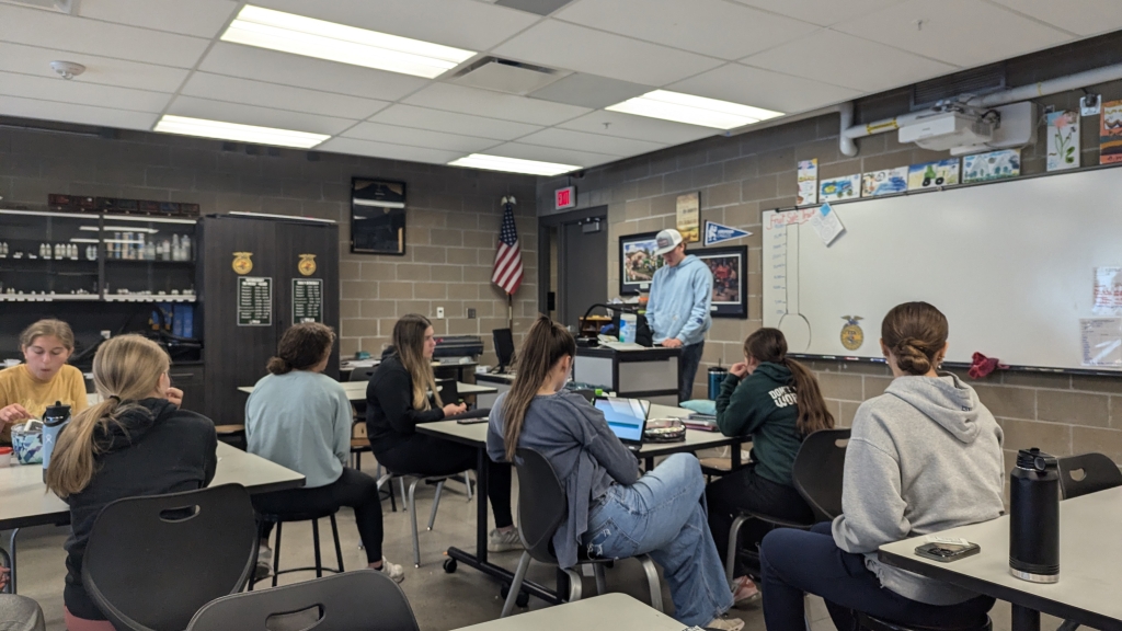 Pella FFA public relations committee members meet to discuss the latest edition of their chapter newsletter.