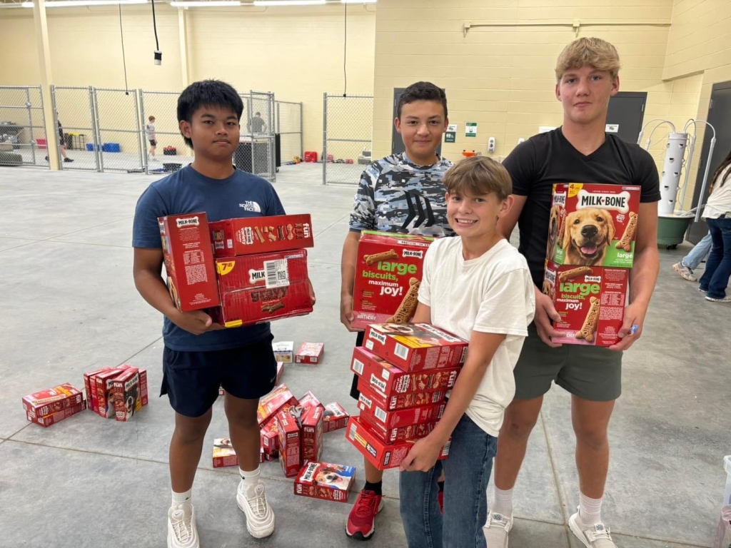 Reagan Thang, Gus Wood, Isaac Cluck and Brennen Gwinn collect dog bones to add to the donations.