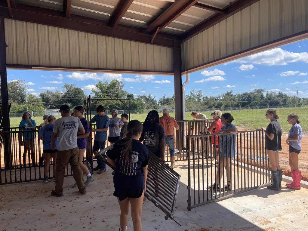 FFA members, their families and community members bonded while setting up the new barn.