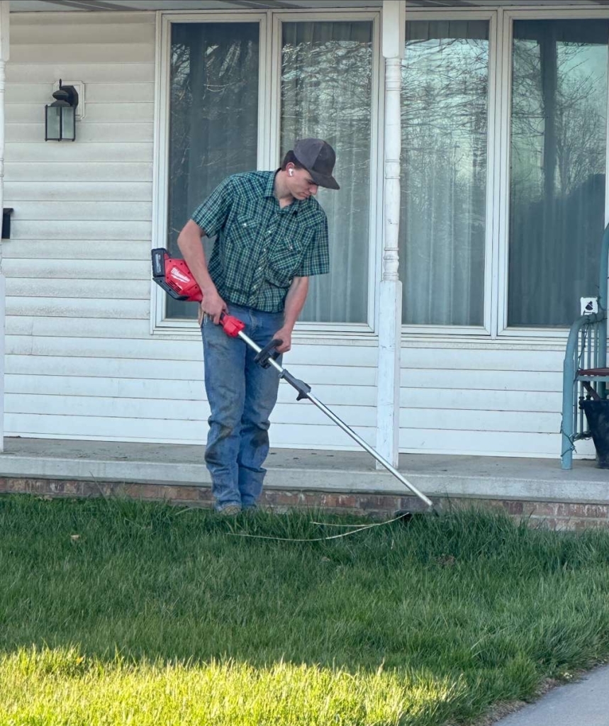 Wyatt working on tidying up a downtown lawn. 