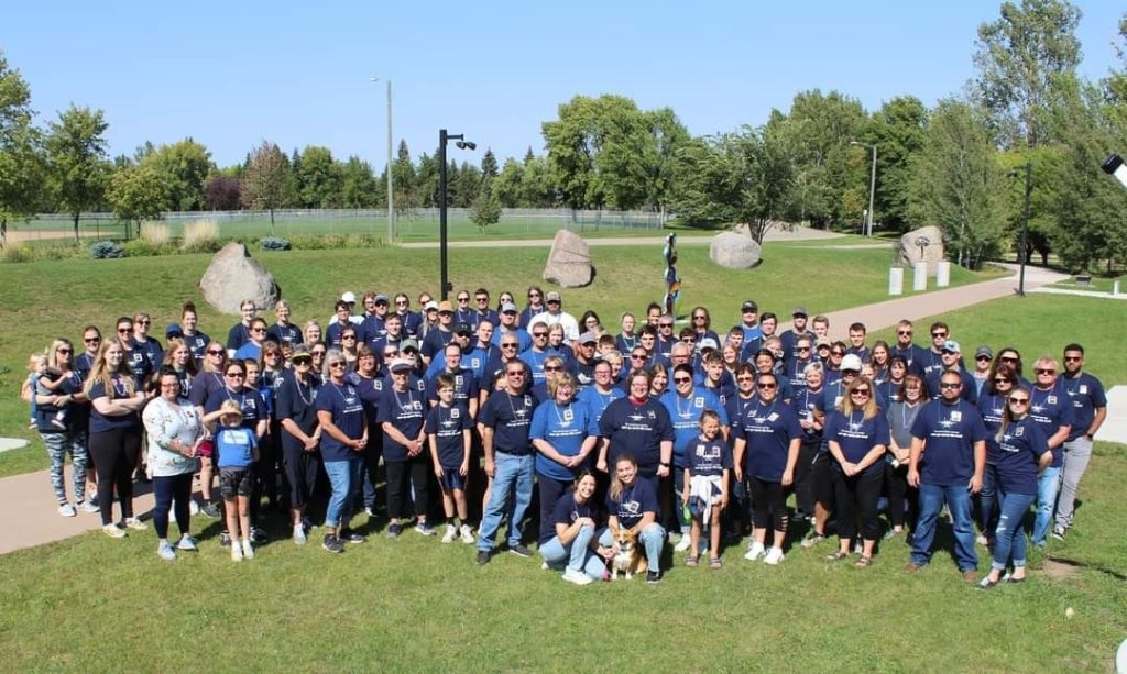 A group of people who participated in one of the Out of the Darkness Walks.