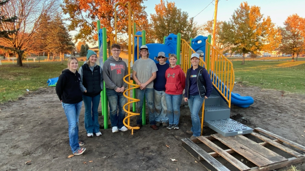 Rock County FFA Chapter Officers set up new playground equipment in efforts to improve the city park.