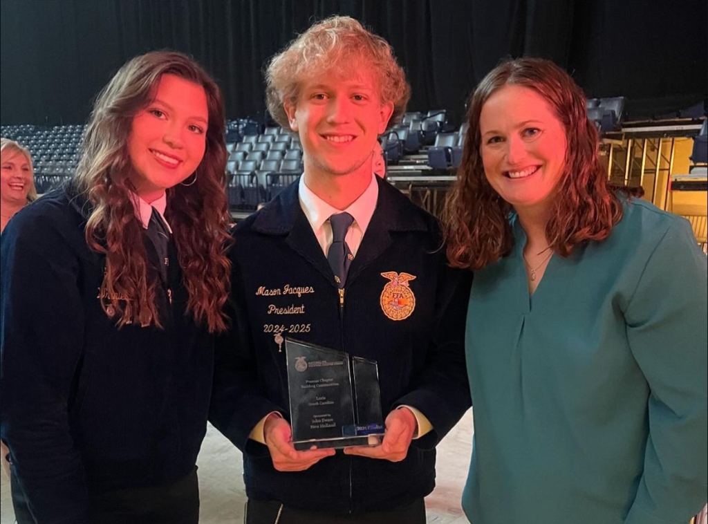 Loris FFA Chapter President, Mason Jacques, with their National Chapter Award.