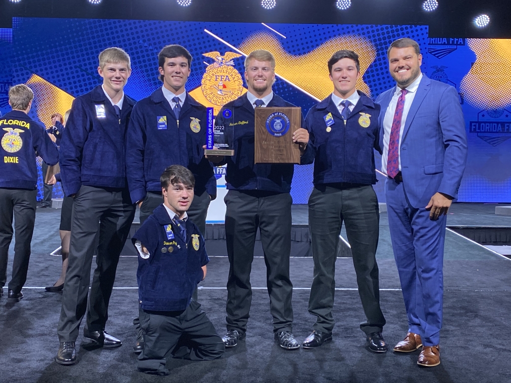 Courson (far right) was recognized by the Blue Angels for his continued commitment to helping his students and FFA members succeed.