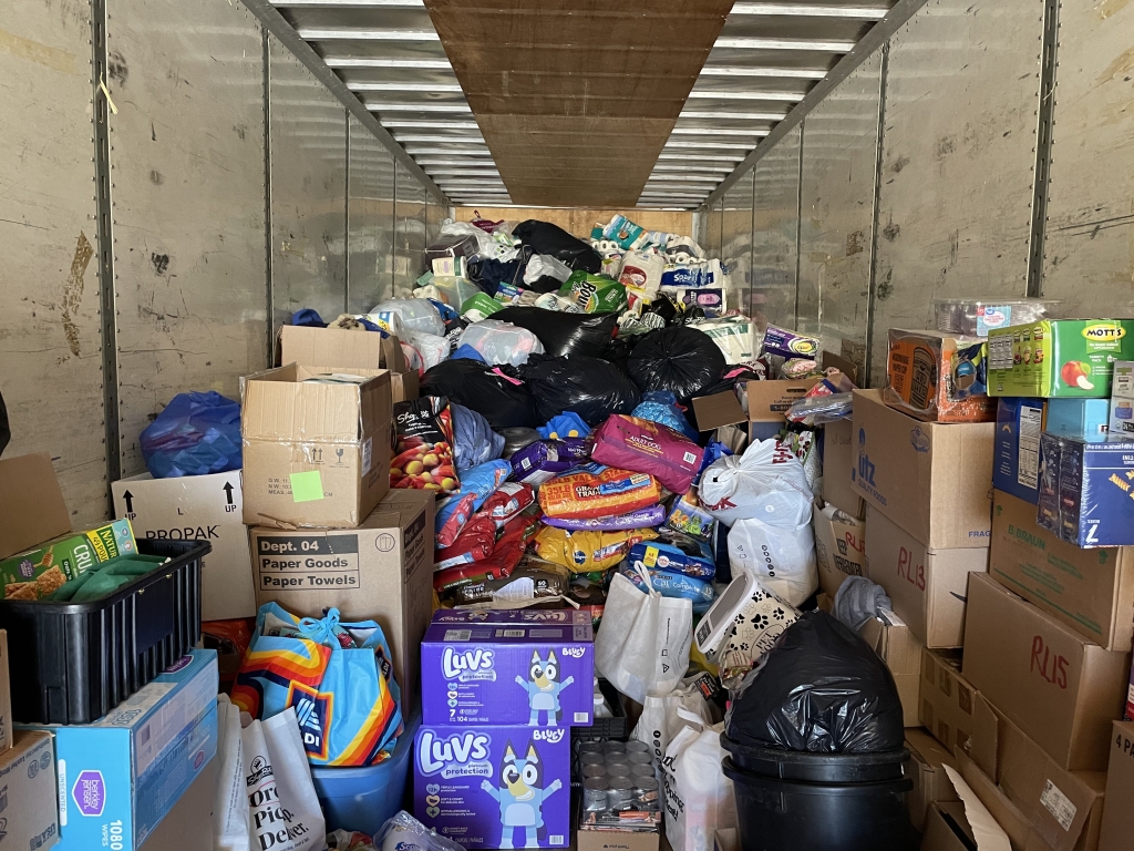 The donation trailer is filled with water, sanitary products, food and livestock equipment.