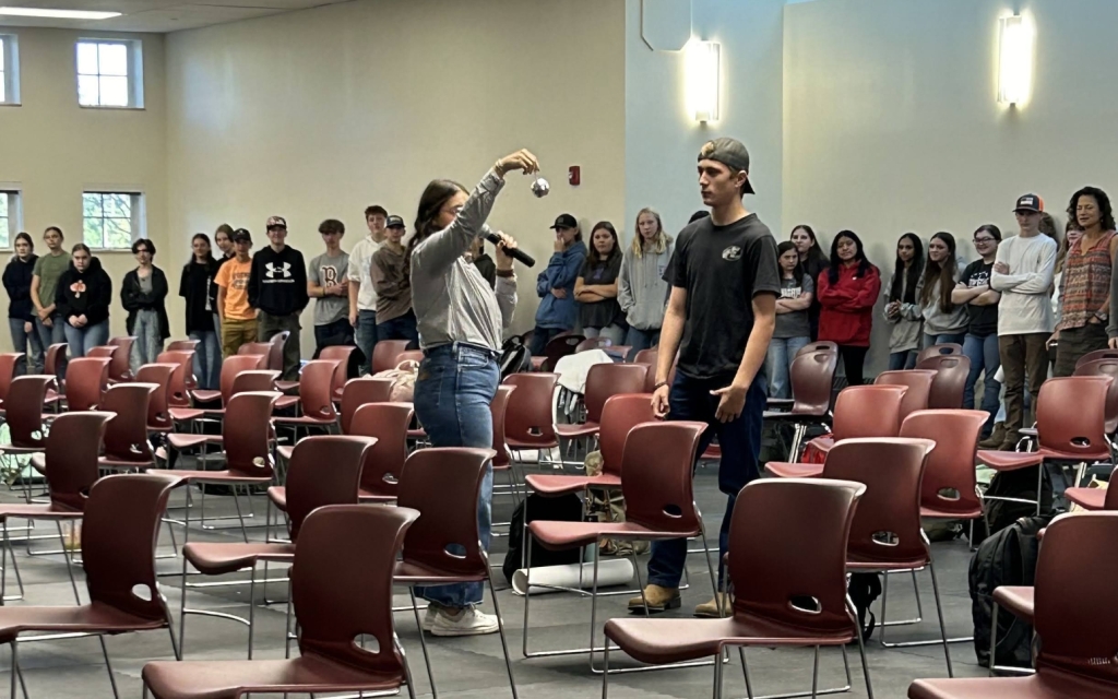 Gossett utilizes a disco ball during an activity on teamwork.