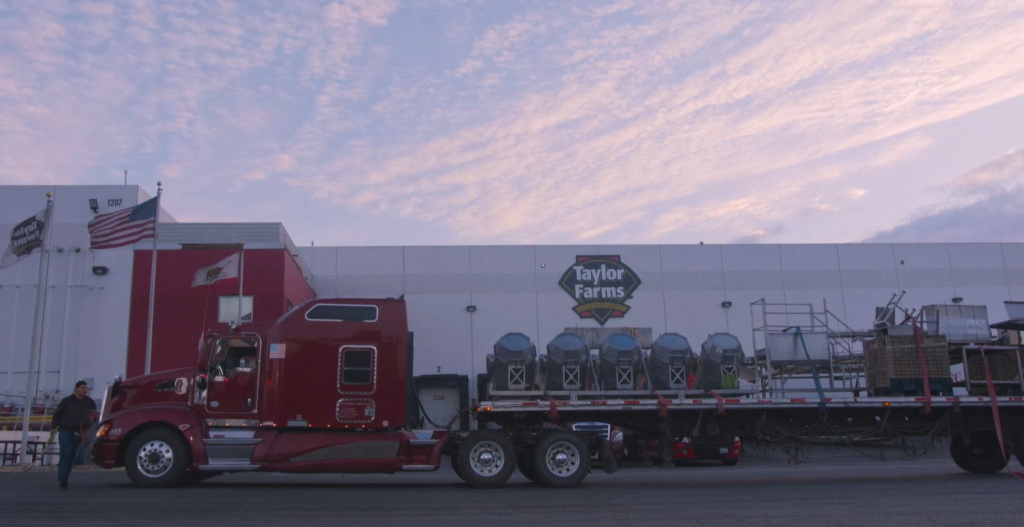 A truck loaded with equipment waits outside the Taylor Farms facility early in the morning.