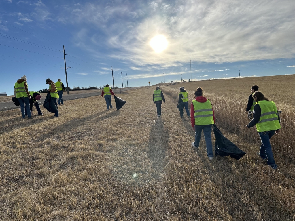 Conrad FFA members walk with their trash bags, picking up pollution and trash.