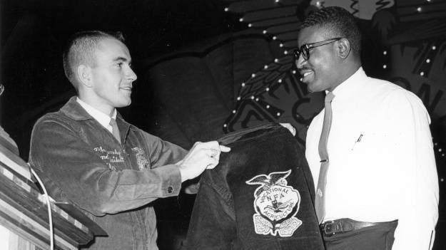 (left) during the 1965 merger ceremony. Photo courtesy of the IUPUI Ruth Lilly Special Collections and Archive.