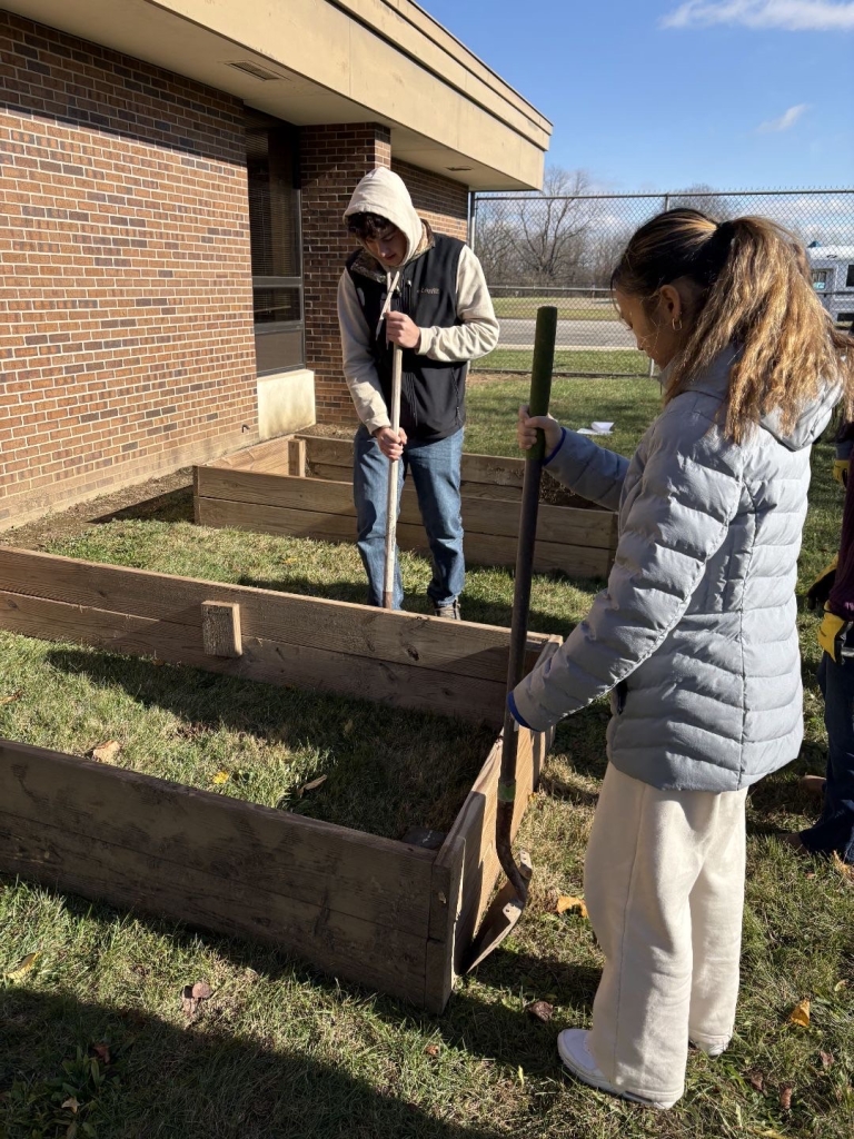 Akey working on the construction of the garden beds.