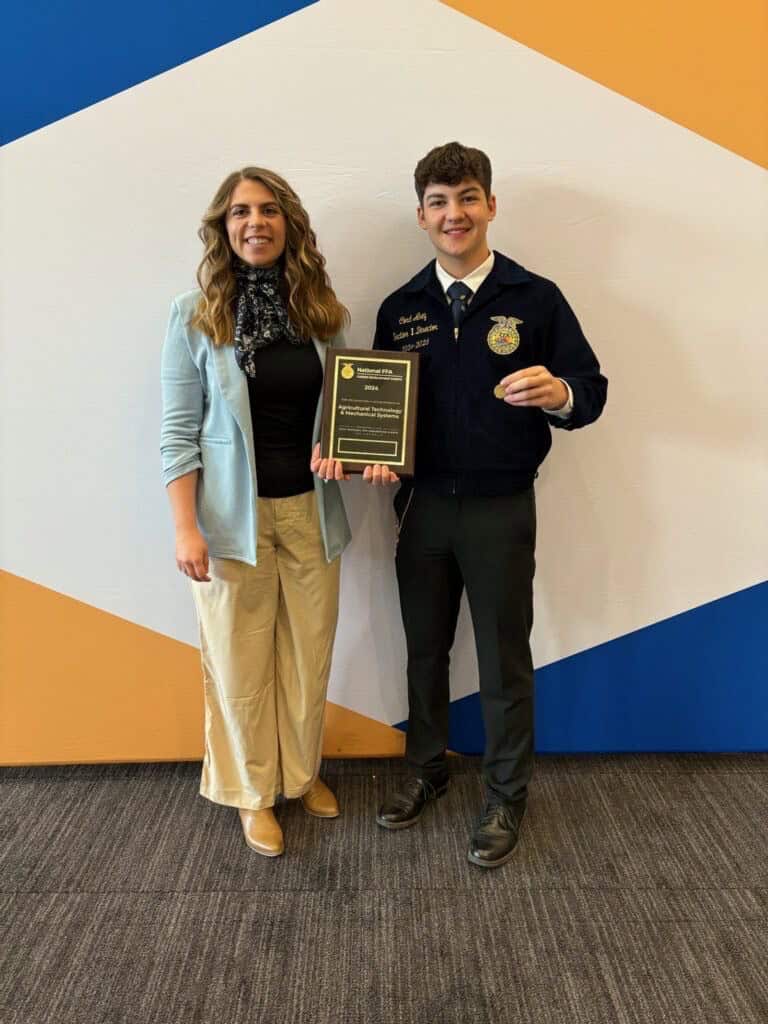 Akey with DeKalb FFA advisor Rebekah Peterson.