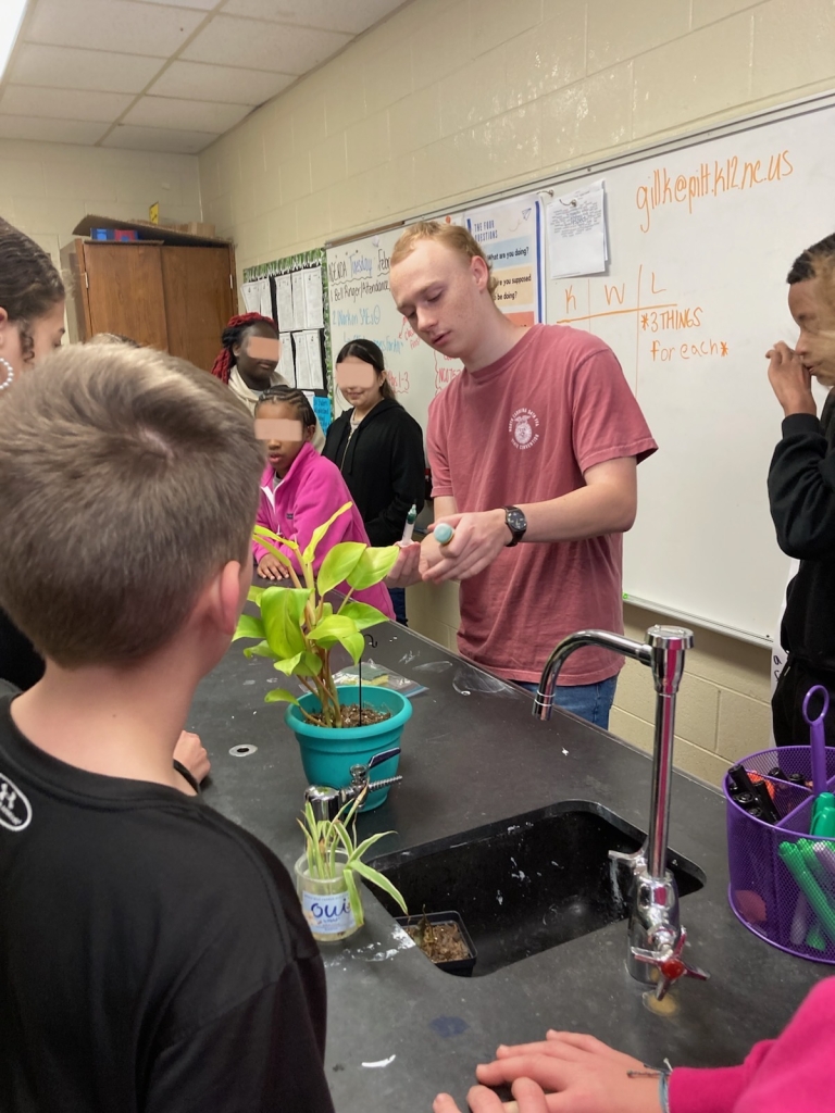 Powell teaches students how to properly insert a vaccine.