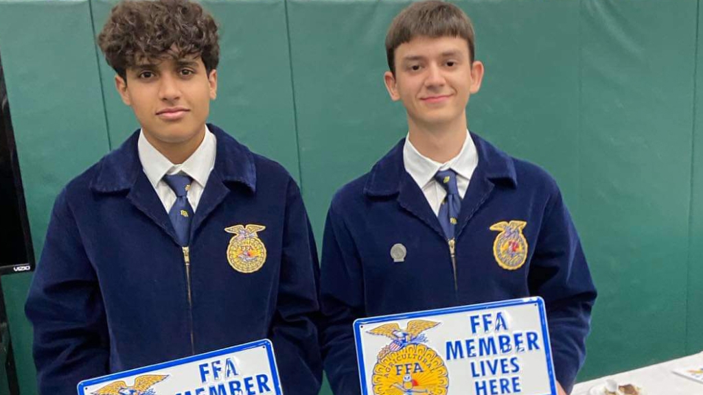 Through their membership in the Ridgemont FFA Chapter in Ohio, exchange students Youssef Belhaj (left) and Eldar Musayev (right) wore the FFA jacket for the first time and received custom signs. Photo courtesy of Eldar Musayev.