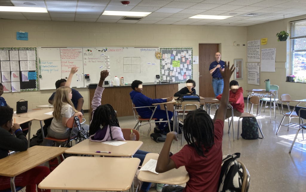 Michael Powell teaches middle school students about agriculture.