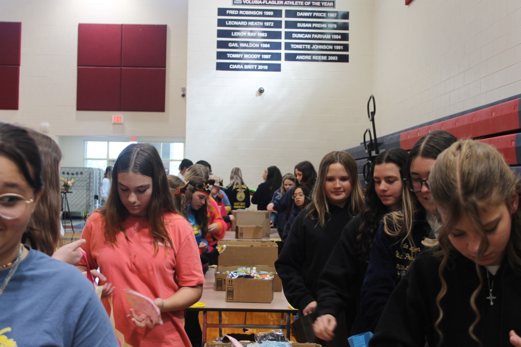 Members work to assemble the care packages.