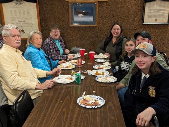 Chapter Vice President Isabel Riley (far right) sits with supporting community members.