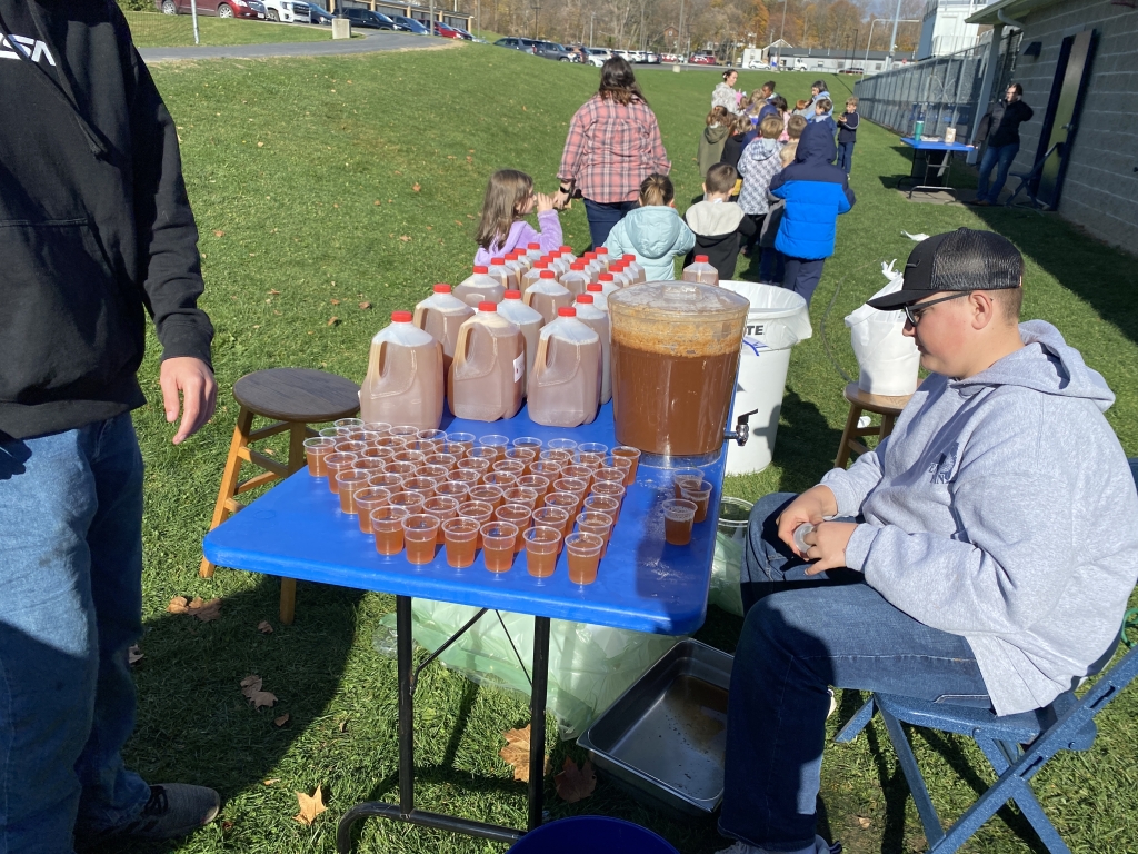 Penn Yan FFA member Jaxon Jensen serves apple cider.