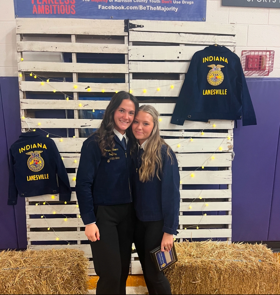 Stewart (left) received the Lanesville FFA Chapter president position from her cousin, Libby (right).